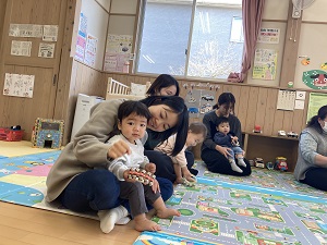鈴でリズム遊びをする親子たち