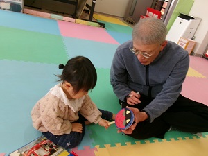 でんでん太鼓を作る祖父と孫